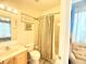 Cozy bathroom with a neutral colored shower curtain and light wood vanity at 8557 La Isla Dr, Kissimmee, FL 34747