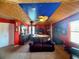 Bedroom with a unique design featuring a bed with columns, a seating area, and a mural at 8557 La Isla Dr, Kissimmee, FL 34747