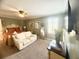 Comfortable bedroom featuring a cozy seating area, plush carpet, and bright natural light at 8557 La Isla Dr, Kissimmee, FL 34747