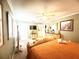 Bedroom boasting an orange comforter set, bright natural light, and neutral colored walls at 8557 La Isla Dr, Kissimmee, FL 34747