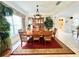 Formal dining room with wood table and view of kitchen at 8557 La Isla Dr, Kissimmee, FL 34747