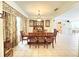 Formal dining room featuring a tile floor, traditional furniture, and elegant decor at 8557 La Isla Dr, Kissimmee, FL 34747