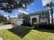 Two-story house with a three-car garage and landscaped yard at 8557 La Isla Dr, Kissimmee, FL 34747