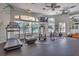 Bright gym with treadmills, bikes, and other fitness machines overlooking the pool at 8557 La Isla Dr, Kissimmee, FL 34747
