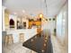 Open kitchen with a breakfast bar, wooden stools, stainless steel appliances, and a view of the living area at 8557 La Isla Dr, Kissimmee, FL 34747