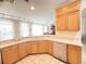Bright kitchen features wood cabinets, white countertops, and modern appliances and an eat-in nook at 8557 La Isla Dr, Kissimmee, FL 34747