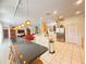 Open floor plan shows the kitchen with a breakfast bar, leading into a living room with red couches at 8557 La Isla Dr, Kissimmee, FL 34747