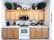 Bright kitchen with wood cabinets and stainless steel appliances at 8557 La Isla Dr, Kissimmee, FL 34747