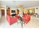 Spacious living room with tile floors, comfortable seating, and an open floor plan that leads into the dining area at 8557 La Isla Dr, Kissimmee, FL 34747