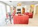 Spacious living room featuring red sofas and chairs, a large TV, and neutral tile flooring at 8557 La Isla Dr, Kissimmee, FL 34747