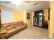 Neutral-carpeted upstairs living space with a comfortable sofa, large TV, and elegant decor at 8557 La Isla Dr, Kissimmee, FL 34747