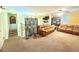 Upstairs loft area with comfortable brown couches, neutral carpeting, and a decorative screen at 8557 La Isla Dr, Kissimmee, FL 34747