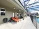 Relaxing patio with lounge chairs near the screened pool at 8557 La Isla Dr, Kissimmee, FL 34747