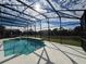 Relaxing screened pool area overlooking a lake at 8557 La Isla Dr, Kissimmee, FL 34747