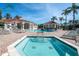 Pool area with palm trees, lounge chairs, spa, and manicured landscaping at 8557 La Isla Dr, Kissimmee, FL 34747