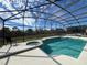 Inviting screened pool and spa with a tranquil view at 8557 La Isla Dr, Kissimmee, FL 34747