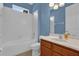 Clean bathroom with a shower/tub combo and wood vanity at 8737 Leeland Archer Blvd, Orlando, FL 32836