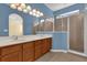 Large bathroom with dual sinks, a shower, and light blue walls at 8737 Leeland Archer Blvd, Orlando, FL 32836