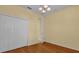 Spacious bedroom with hardwood floors and double doors leading to the ensuite bathroom at 8737 Leeland Archer Blvd, Orlando, FL 32836