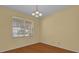 Bright dining room with hardwood floors and a window with blinds at 8737 Leeland Archer Blvd, Orlando, FL 32836