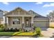 Attractive Craftsman style home with two-car garage and well-manicured landscaping at 8737 Leeland Archer Blvd, Orlando, FL 32836