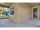 Covered front porch with neutral colored walls and a door leading into the home at 8737 Leeland Archer Blvd, Orlando, FL 32836