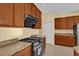 Modern kitchen with gas range and ample cabinetry at 8737 Leeland Archer Blvd, Orlando, FL 32836