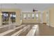 Spacious living room with tile floors, sliding doors to patio, and large windows at 8737 Leeland Archer Blvd, Orlando, FL 32836