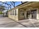 Large screened patio with access to the house and a view of the backyard at 8737 Leeland Archer Blvd, Orlando, FL 32836