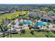 Aerial view of community pool, clubhouse, and surrounding homes at 8899 Fallen Oak Dr, Davenport, FL 33836