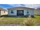 Rear view of house with screened patio and yard at 8899 Fallen Oak Dr, Davenport, FL 33836