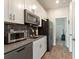 Small kitchen featuring white cabinets and stainless steel appliances at 8899 Fallen Oak Dr, Davenport, FL 33836