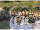 Townhouses next to a golf course with palm trees and paved driveways at 904 Assembly Ct, Reunion, FL 34747