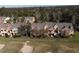 Row of townhouses with grey roofs and orange siding, near a golf course at 904 Assembly Ct, Reunion, FL 34747