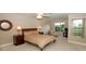 Spacious bedroom with large window, ceiling fan, and sitting area at 904 Assembly Ct, Reunion, FL 34747