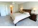 Bright bedroom with carpeted floors and double doors to the bathroom at 904 Assembly Ct, Reunion, FL 34747