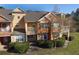 Two-story townhouse with balconies, orange and tan exterior, and landscaping at 904 Assembly Ct, Reunion, FL 34747