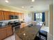 Modern kitchen with granite countertops and stainless steel appliances at 904 Assembly Ct, Reunion, FL 34747