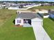 Aerial view of a house with a large yard and shed at 905 Desmoines Way, Poinciana, FL 34759