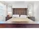 Main bedroom with king-size bed and arched mirrors at 905 Desmoines Way, Poinciana, FL 34759