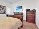 Main bedroom with king-size bed and wood furniture at 905 Desmoines Way, Poinciana, FL 34759