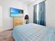 Bedroom with dresser, TV and blue bedding at 905 Desmoines Way, Poinciana, FL 34759