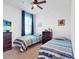 Bedroom with twin beds, dresser and TV at 905 Desmoines Way, Poinciana, FL 34759