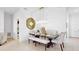 Elegant dining room with chandelier, bench seating, and large mirror at 905 Desmoines Way, Poinciana, FL 34759