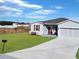 Newly built home with a large front yard and driveway at 905 Desmoines Way, Poinciana, FL 34759