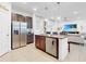 Open concept kitchen with island and stainless steel appliances at 905 Desmoines Way, Poinciana, FL 34759