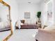 Living room with couch, chair, large mirror, and natural light at 905 Desmoines Way, Poinciana, FL 34759