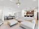 Open concept living space with L-shaped sectional and adjacent kitchen at 905 Desmoines Way, Poinciana, FL 34759