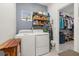 Bright laundry room with washer, dryer, and ample storage at 939 Braewood Dr, Clermont, FL 34715