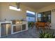 Stainless steel appliances and granite countertops highlight this outdoor kitchen at 939 Braewood Dr, Clermont, FL 34715